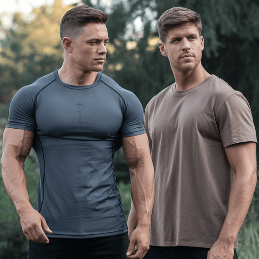 Man wearing a muscle top and another man wearing a traditional t-shirt. The man in the muscle top has defined abs and biceps. He is standing outdoors with a backdrop of trees. The man in the traditional t-shirt has a casual posture. 